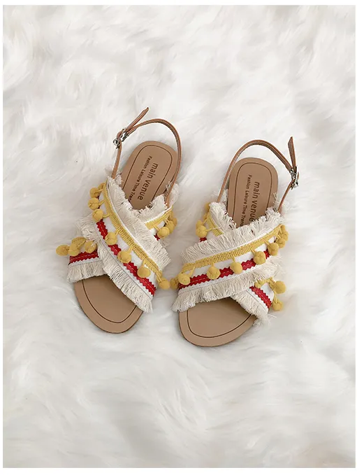 BOOPDO DESIGN CROSS OVER FLAT SANDALS WITH TASSEL AND POM POM DETAIL