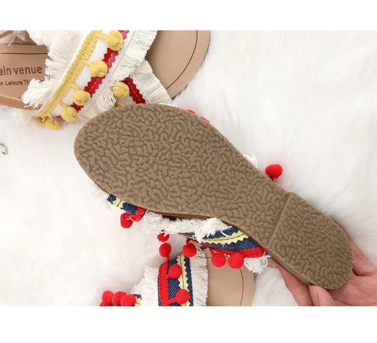 BOOPDO DESIGN CROSS OVER FLAT SANDALS WITH TASSEL AND POM POM DETAIL