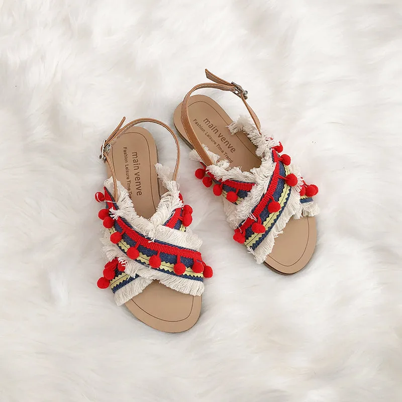 BOOPDO DESIGN CROSS OVER FLAT SANDALS WITH TASSEL AND POM POM DETAIL