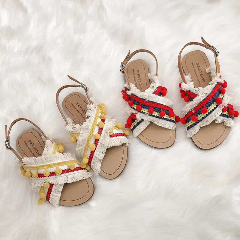 BOOPDO DESIGN CROSS OVER FLAT SANDALS WITH TASSEL AND POM POM DETAIL