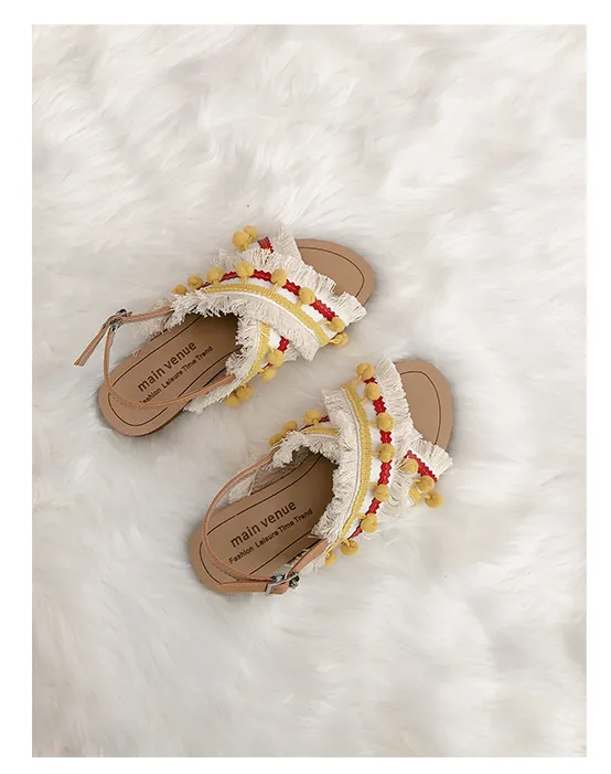BOOPDO DESIGN CROSS OVER FLAT SANDALS WITH TASSEL AND POM POM DETAIL