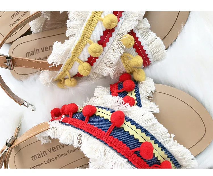 BOOPDO DESIGN CROSS OVER FLAT SANDALS WITH TASSEL AND POM POM DETAIL