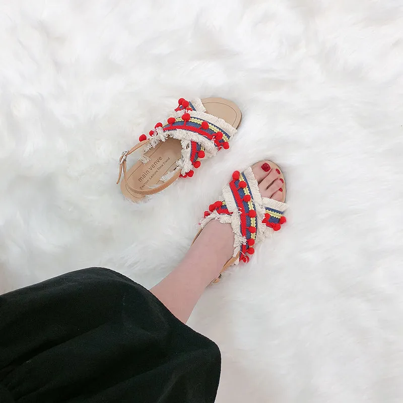 BOOPDO DESIGN CROSS OVER FLAT SANDALS WITH TASSEL AND POM POM DETAIL